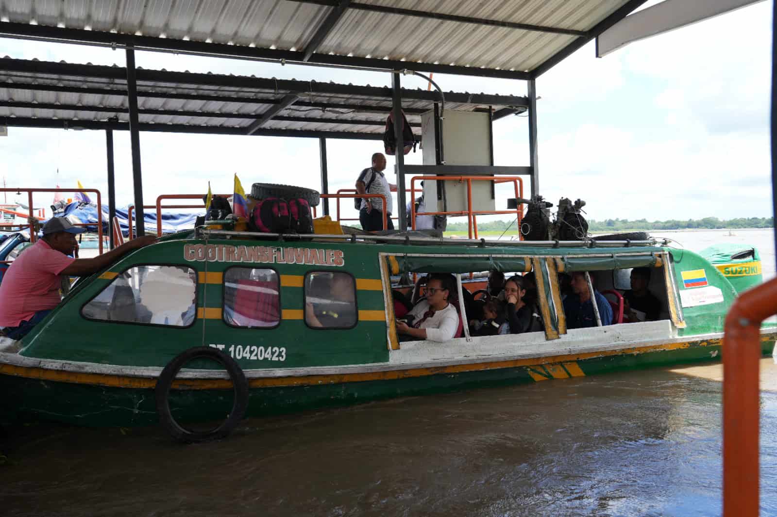 Embarcación de transporte fluvial de pasajeros atracada en un muelle, con viajeros a bordo durante una jornada de inspección y vigilancia de la Superintendencia de Transporte.